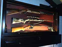 Custom Gun Cabinet crafted with wall hanging display with rifles in place.