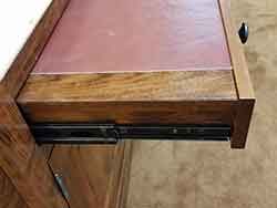 Full extension drawer glides on the leather top rifle and pistol shelf.