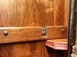 Wood clad steel locking bar peg hole in the gun cabinet.