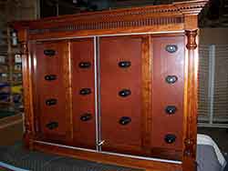 Custom Pistol Cabinet crafted out of solid cherry with leather back