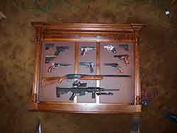 Amish made custom pistol wall cabinet with pistols and long guns