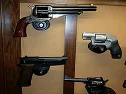 Pistol and Rifle Trigger Locks Mounted to Display Cabinet