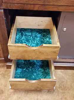 Full extension felt lined gun cabinet storage drawers.