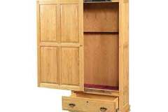 A single door sliding front gun cabinet crafted out of solid red oak with a honey stain finish.