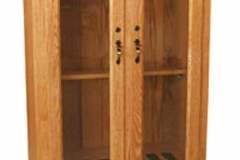 This gun cabinet was Amish crafted with hidden hinges on the two upper arched doors.  Hidden hinges and embedded into the doors and connect to the interior of the gun cabinet.