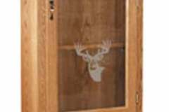 This gun cabinet features a single large arched glass display door, sculptured upper molding, dentil molding accent, and two full extension lower drawers for all of your gun accessories.