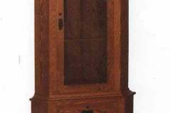 The mission corner gun cabinet showcases flush mount doors and drawers, full view glass door with mission mullions, and two full extension lower drawers.  Shown crafted out of solid red oak with hammers mission hardware.