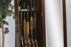 When you slide the full length framed mirror to the side you have quick access to your long gun collection as well as pistols and all your gun accessories.