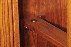 Our gun cabinets can be crafted with a wide assortment of different security measures.  This interior shot shows our standard solid wood locking bar with cylinder lock to prevent long gun removal.