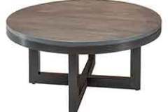 The Walnut wood top highlights this round coffee table. The custom made powder coated metal legs support the size of it.