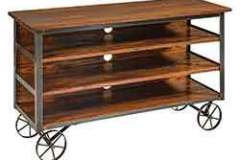 Our reclaimed barn wood tv stand is seen here. It also has wheels for easy transportation.