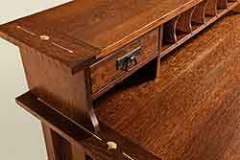 The topper for this custom desk has the matching inlay on it as well. They both also have a bread board end.
