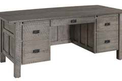 5 drawer custom Mission executive desk. It also has flat panel in the knee hole area and is shown in rough sawn wood with a gray stain.