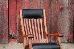 Our custom Queen Anne lounge chair is seen here. It comes standard with black leather and gold nail head tacks.