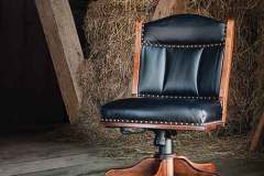 The black leather shows off this custom Amish made Low Back desk chair. It is made with Brown Maple wood with Michael's Cherry stain.