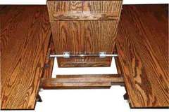 This is what the custom butterfly table looks like when folded in half. It then lays flat and stores under the Amish made table top.