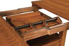 The butterfly leaf mechanism of the Bassett cabinet table.
