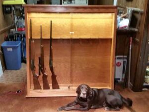 Front Display of Large Gun Cabinet with Loki the Store Dog