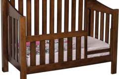 Take that Mission style custom crib and make it into a toddler bed with a guard rail on the front.