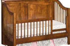 Here is the Tannessah Crib converted to a toddler bed with the front guard rail.  Shown crafted out of solid Brown Maple wood.