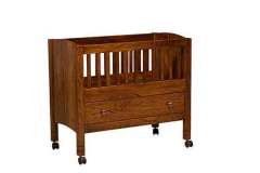 This custom Amish Bassinet and drawer are shown in Elm wood with Michael's Cherry stain.