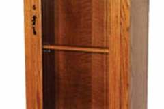 This Amish made gun cabinet features a single locking door, two locking drawers, and a beautiful molding with fine dentil work below.  Shown crafted out of solid red oak with a S-2 stain color.