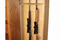 The Slide out extension on the hidden gun pull out can hold up to 7 guns and the bookcase cabinet can be crafted to have pull out extensions on both sides of the cabinet.