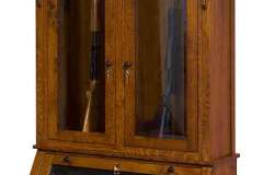 This Breckenridge gun cabinet has 2 doors and an angled pistol display. Shown in quarter Sawn Oak wood.