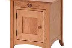 This is our Shaker Hill cabinet end table seen in Oak wood. This one has a flat panel door and end.