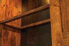 What you have here is an example of our custom wood framed glass shelf. This makes that shelf a lot more sturdy than just plain glass and is available on any cabinet with shelves.
