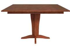 Here is our Amish made Vintage Single Pedestal Table. It is done in Cherry wood with a rectangular top. It can have either a solid top or up to 2 leaves.