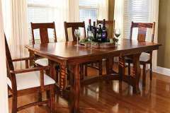 Shown is the Reno Trestle Table with padded seat chairs.