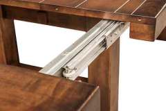 Shows the roller bearing table slide on the Wellington Trestle table.